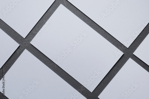 White blank cards, On a grey background white and clean paper, symmetrical sheets, space for text 