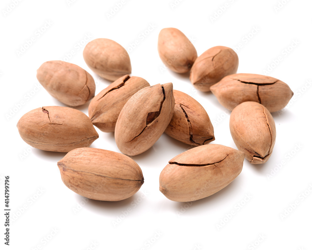 Peeled pecan nuts closeup, isolated on white background