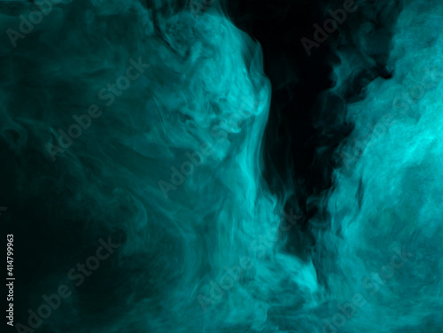 Abstract background of chaotically mixing clouds of turquoise smoke on a background of darkness