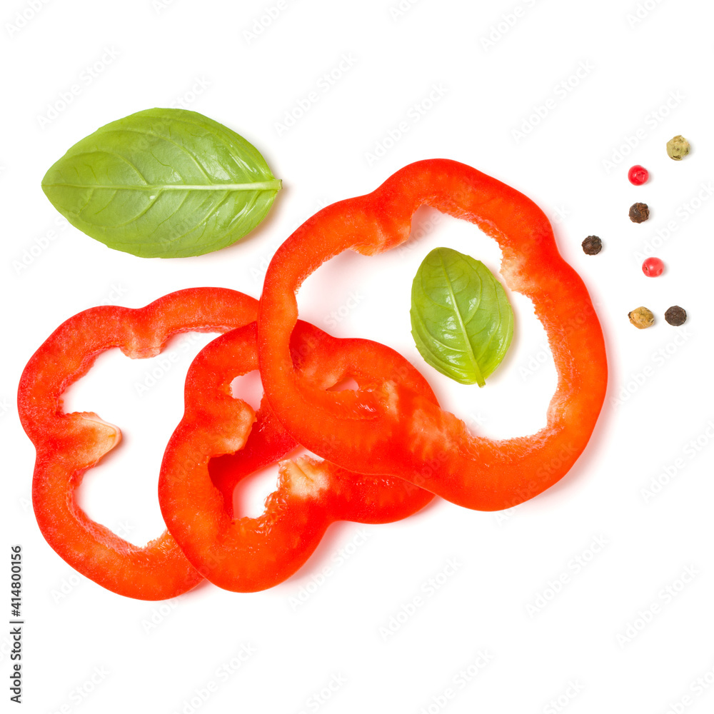 red pepper slices with basil leaves isolated on white background cutout. Top view, flat lay. red pepper slices with basil leaves isolated on white background cutout. Top view, flat lay.