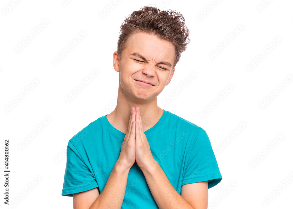 Handsome teen boy with hands folded in prayer hoping for better, isolated on white background Handsome teen boy with hands folded in prayer hoping for better, isolated on white background
