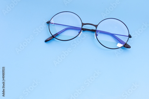 Eye Glasses on blue background. Copy space