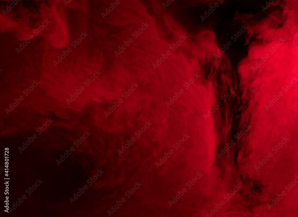 Abstract background of chaotically mixing puffs of red smoke on a dark background