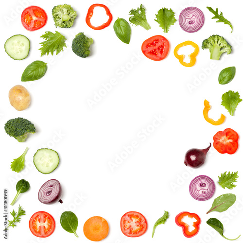Creative layout made of tomato slice, onion, cucumber, basil leaves. Flat lay, top view. Food concept. Vegetables isolated on white background. Food ingredient pattern with copy space.