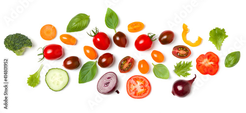 Creative layout made of tomato slice, onion, cucumber, basil leaves. Flat lay, top view. Food concept. Vegetables isolated on white background. Food ingredient pattern.