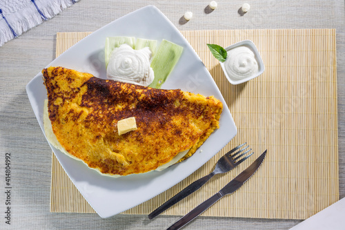 Comida típica de Venezuela servido en plato para restaurante, cachapas con relleno de queso jamón, cochino frito photo