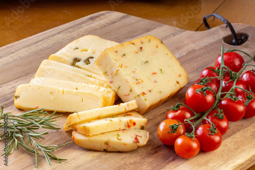 Soft cheese with olives and cheese with chili peppers with tomatoes and rosemary – wood