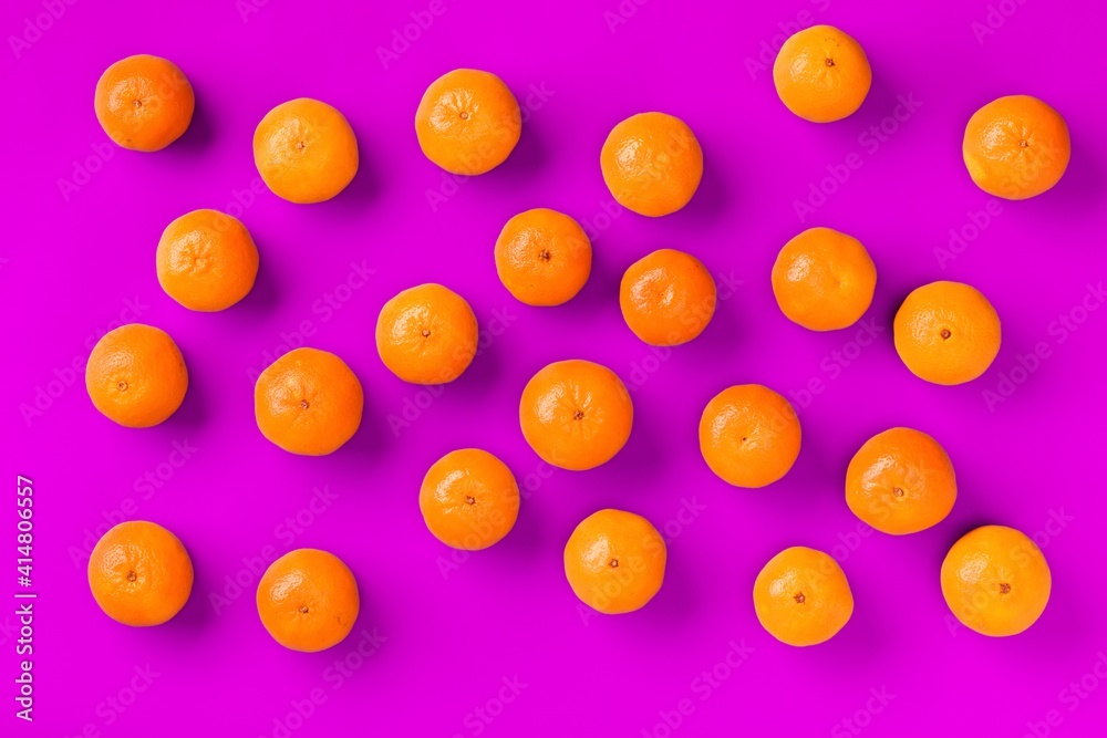 Fruit pattern of fresh orange tangerine or mandarin on lilac background. Flat lay, top view. Pop art design, creative summer concept. Citrus in minimal style. Fruit pattern of fresh orange tangerine or mandarin on lilac background. Flat lay, top view. Pop art design, creative summer concept. Citrus in minimal style.