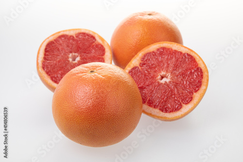 Sliced juicy grapefruits isolated on white