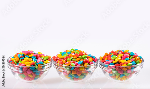 Colored chewing gum in glass bowls - White background