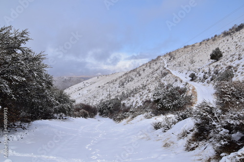 Snowy Hiking Trail views towards Lake Mountains Peak via Israel Canyon road towards Radio Towers in winter, Utah Lake, Wasatch Front Rocky Mountains, Provo, United States.