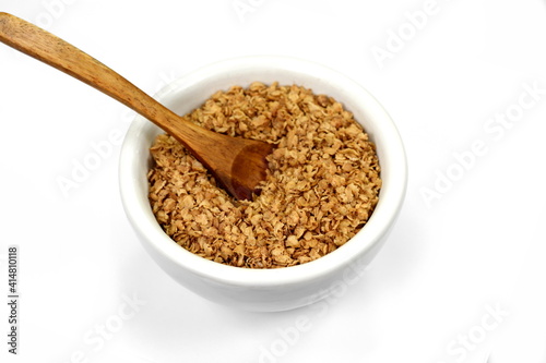 Fototapeta Naklejka Na Ścianę i Meble -  Buckwheat flakes in a bowl isolated on white background. Healthy buckwheat flakes. Healthy food.
