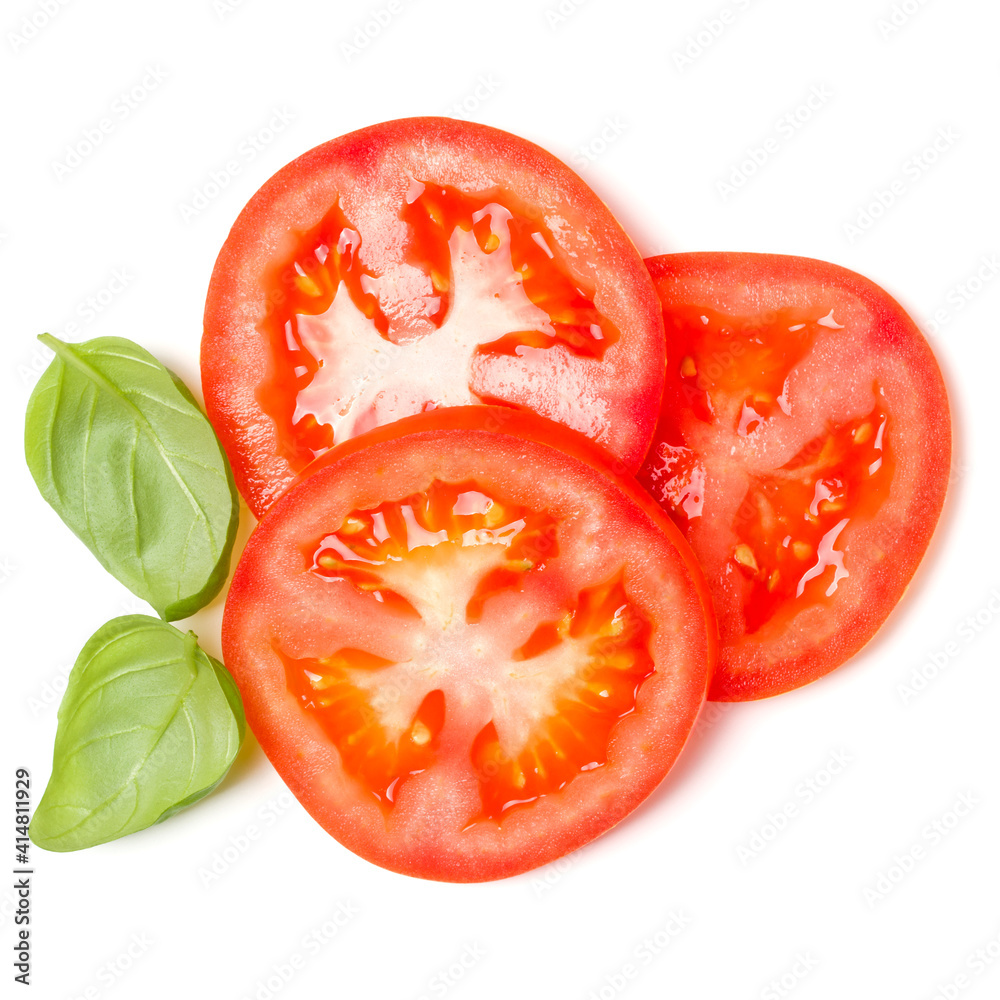 Slices of tomato and basil leaves isolated over white background. Top view, flat lay.. Slices of tomato and basil leaves isolated over white background. Top view, flat lay..