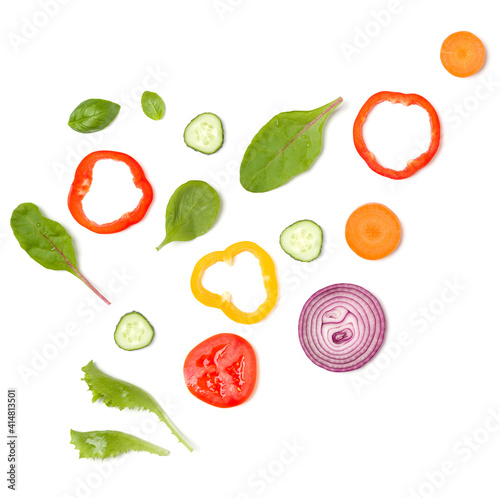 Creative layout made of tomato slice  onion  cucumber  basil leaves. Flat lay  top view. Food concept. Vegetables isolated on white background. Food ingredients pattern.