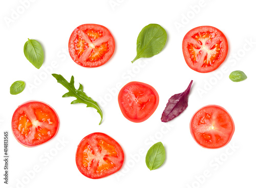 Creative layout made of tomato slices and lettuce salad leaves. Flat lay  top view. Food concept. Vegetables isolated on white background. Food ingredients pattern.