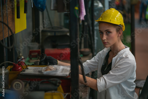 Worker factory women concept. Inspection technician, factory engineer, inspection of the machine condition in the factory. Inspection by technicians, industrial business, production machinery © Me studio