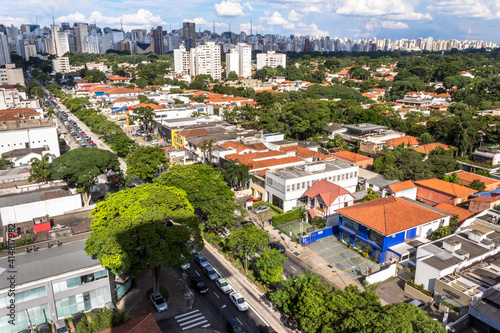 Aerial view of Reboucas Avenue traffic with Jardins district in foreground and skyline in the background, in west side of Sao Paulo city