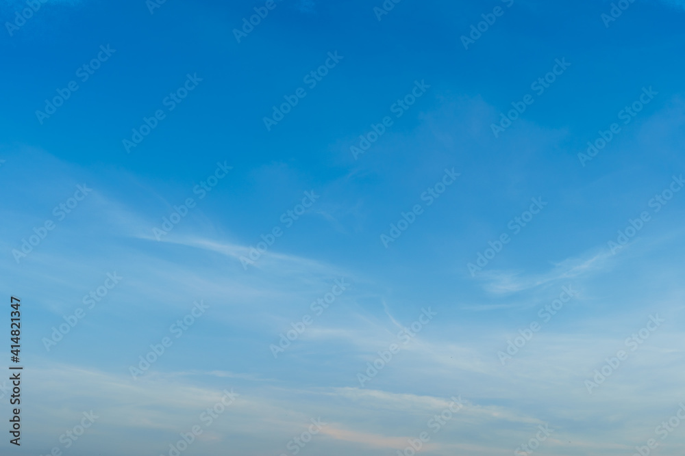 blue bright dramatic sunset sky in countryside or beach colorful cloudscape texture with white clouds air background.