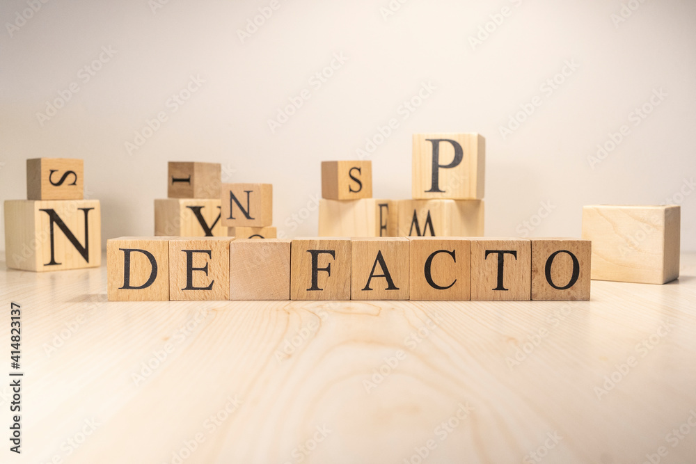 The Defacto Word is from wooden cubes. Terms of state government.