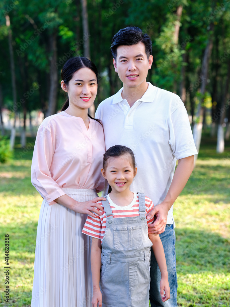 Happy family of three playing in the park Happy family of three playing in the park
