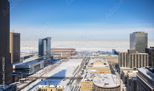 View over Cleveland and fully frozen Lake Erie covered with snow in the winter. If the ice is thick enough, people drive over the frozen lake to cross borders between the USA and Canada. 