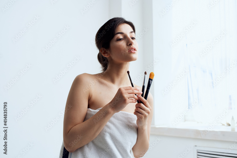 pretty woman in towel bathroom makeup brush skin care pretty woman in towel bathroom makeup brush skin care