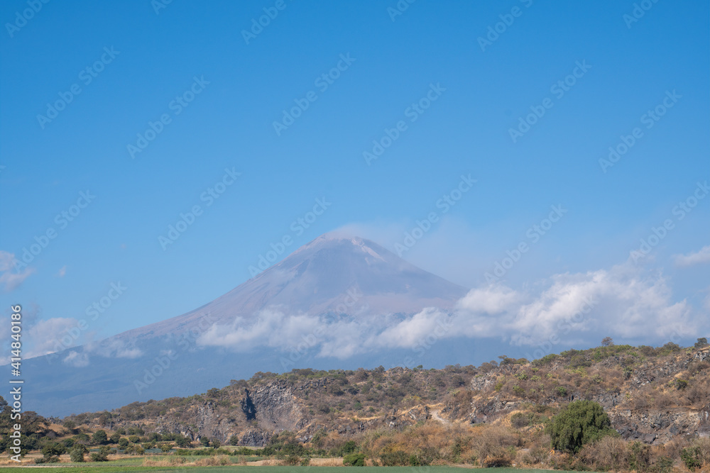 Mesmerizing view of active Popocatepetl volcano in Mexico against a blue sky