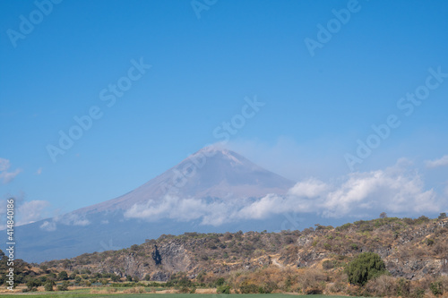 Mesmerizing view of active Popocatepetl volcano in Mexico against a blue sky