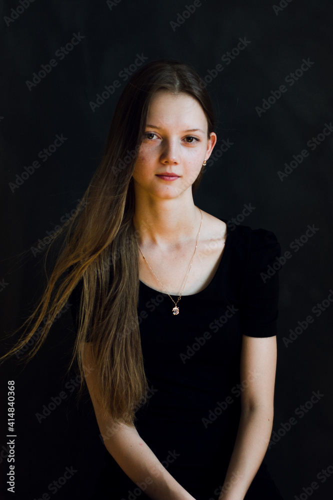 portrait of a young woman in black background portrait of a young woman in black background