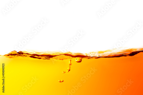 The surface of the orange water ripples looks like beer.