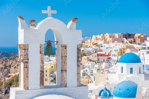 Churches and blue cupolas of Oia town at Santorini, Greece photo