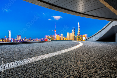 Empty square floor and Shanghai skyline with buildings at night,China.High angle view.
