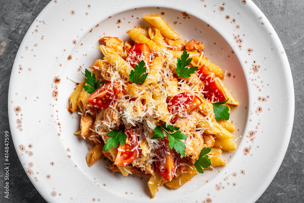 close-up of wholewheat penne bolognese topped with parmesan on a white plate, Italian food. Food recipe background. Close up close-up of wholewheat penne bolognese topped with parmesan on a white plate, Italian food. Food recipe background. Close up