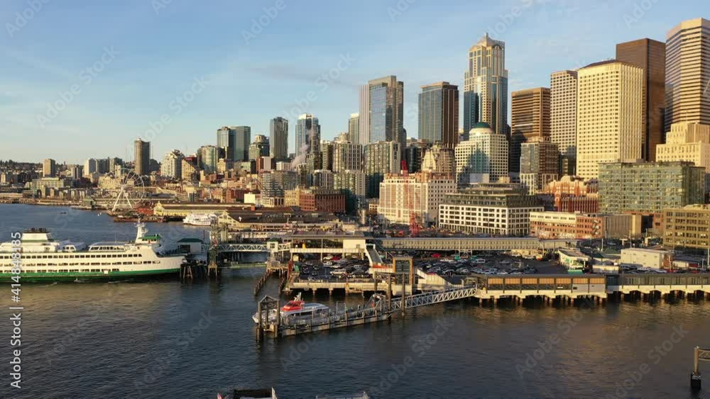 Cinematic bird's-eye shot of the Seattle Bainbridge Ferry, Great Wheel, Seattle Aquarium, Cruise Terminal, Seattle downtown, waterfront, piers, empty Alaskan Way with skyscrapers, during the pandemic Cinematic bird's-eye shot of the Seattle Bainbridge Ferry, Great Wheel, Seattle Aquarium, Cruise Terminal, Seattle downtown, waterfront, piers, empty Alaskan Way with skyscrapers, during the pandemic