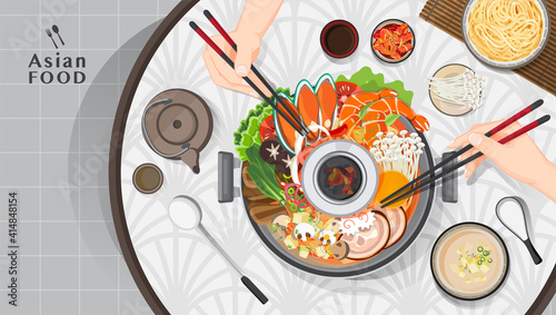 Asian food Shabu Shabu and Sukiyaki in hot pot at restaurant,  Hand holding chopsticks eating Shabu  shabu