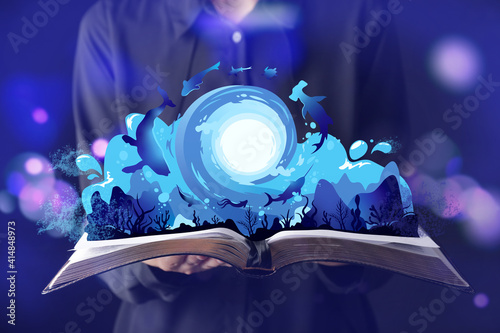 Photography Woman holding book with drawn magic world on dark color background