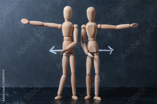 Wooden mannequins with arro...