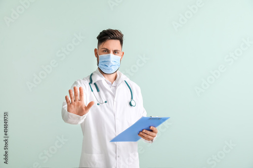 Male doctor showing STOP ge...
