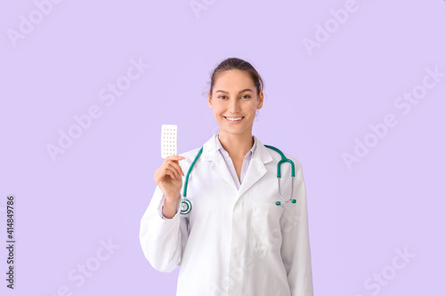 Doctor with pills on color ...