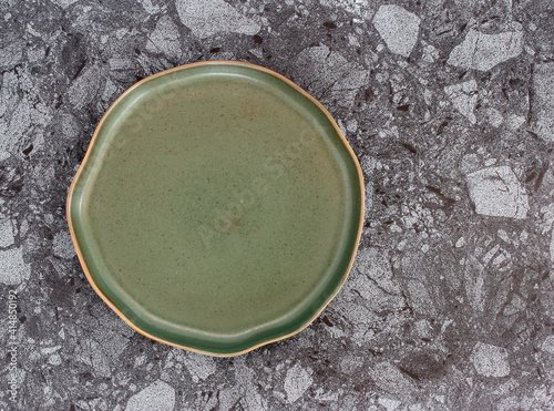 Empty modern ceramic plate on marble table background ,top view