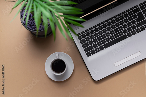 workplace. copyspace. top view. laptop keyboard next to a small cup of espresso coffee