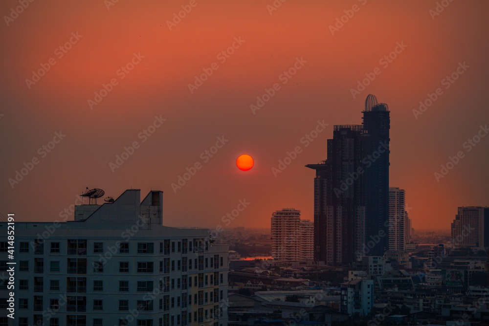 The high angle background of the city view with the secret light of the evening, blurring of night lights, showing the distribution of condominiums, dense homes in the capital community