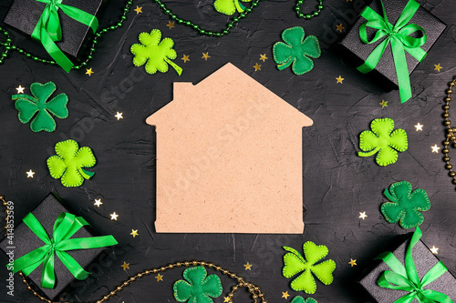 Photography Home symbol surrounded by gifts, four-leaf clover and stars on black background