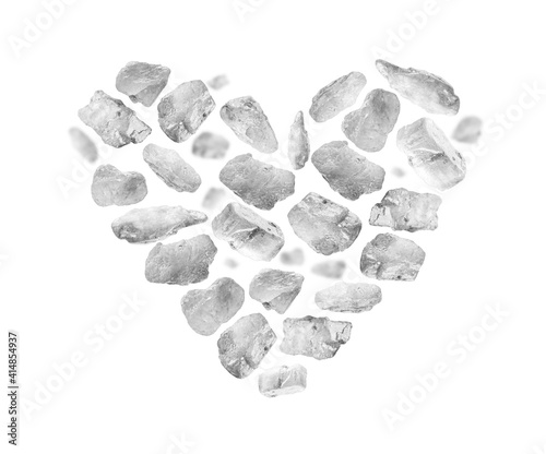 Rock salt close up in the shape of a heart on a white background