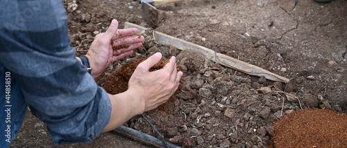 Cropped shot of farmer hands pouring back organic soil.