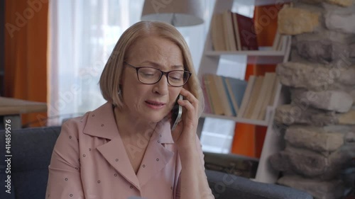 Beautiful little girl spends time with tablet computer or mobile phone in the dark under the duvet. Internet or online game addicted concept.