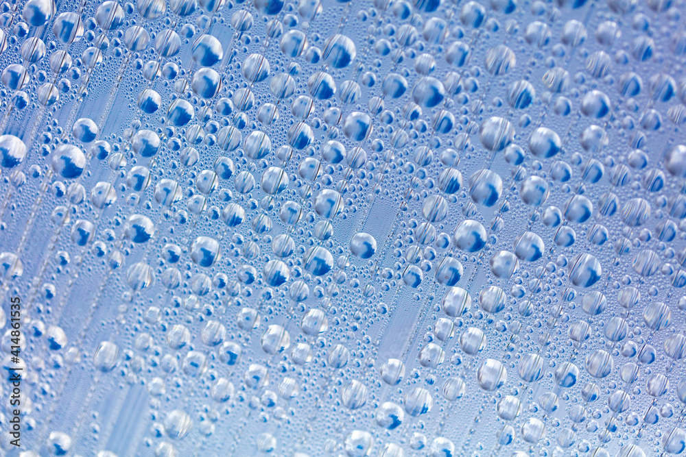 Water drops on blue glass as an abstract background. Water drops on blue glass as an abstract background.