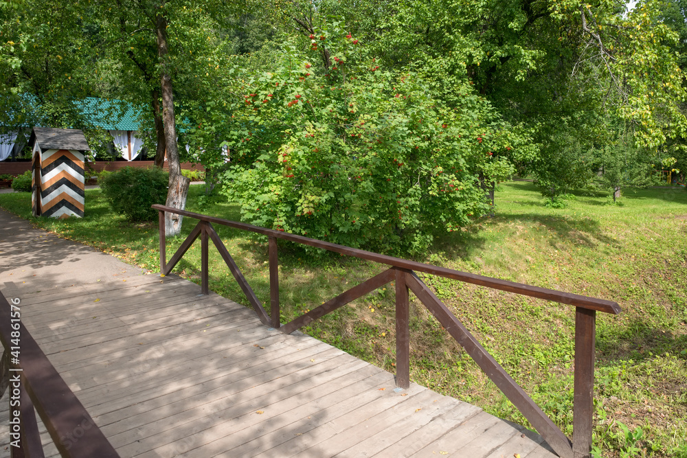 Wooden bridge in the old park on a summer day Wooden bridge in the old park on a summer day