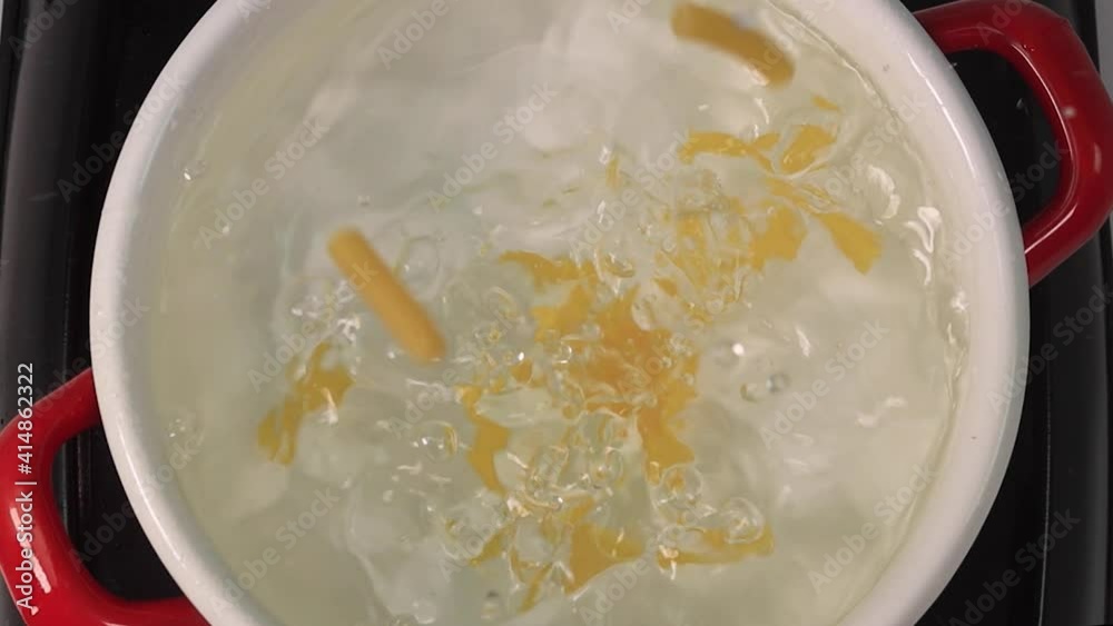 Camera follows throwing penne pasta into water. Overhead shot. Slow Motion. High quality FullHD footage Camera follows throwing penne pasta into water. Overhead shot. Slow Motion. High quality FullHD footage