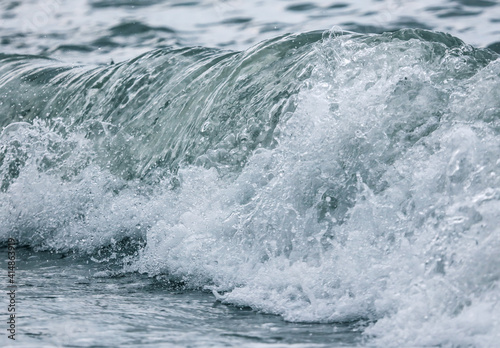 Wave in the sea with splashing water. © schankz